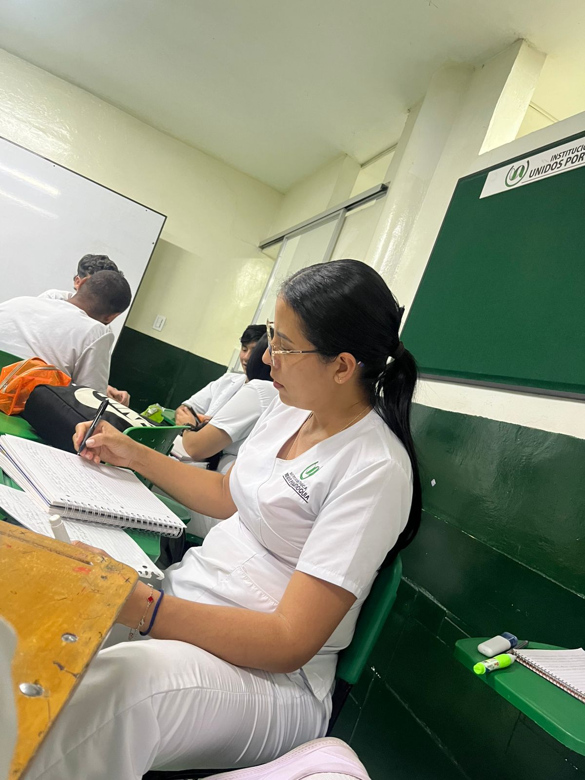 Eglis in nursing-aide uniform in classroom