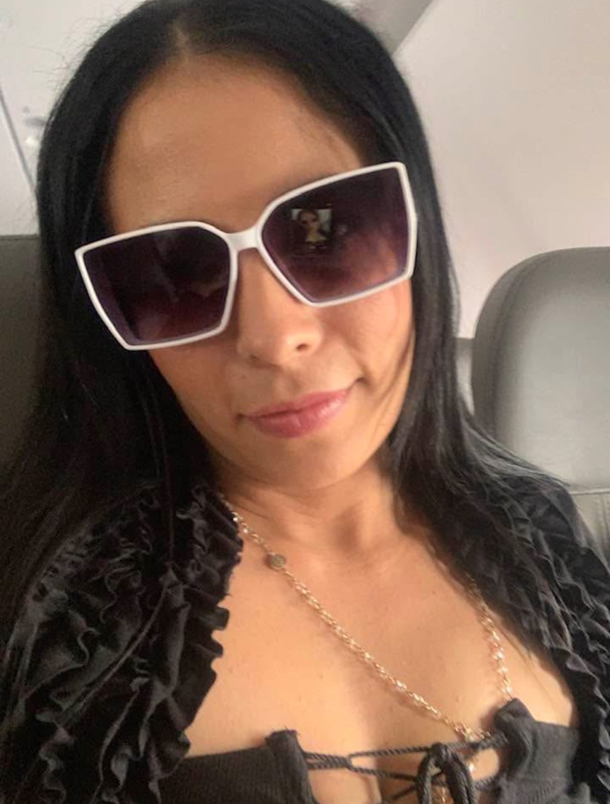 Selfie wearing sunglasses on plane